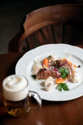 a plate of food on a table with a cup of coffee at Hotel U Císaře in Mirošovice