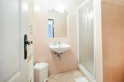 a bathroom with a sink and a toilet and a shower at Hotel U Císaře in Mirošovice