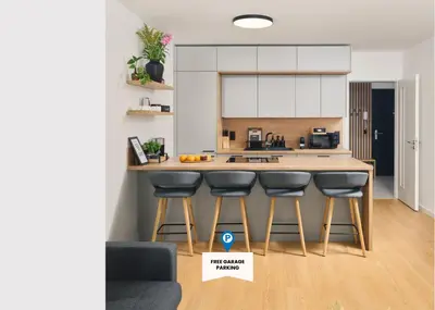 a kitchen with a counter and bar stools at Beta Home - Free Garage, Air Condition, Garden, at Metro, 2nd parking on request in Prague
