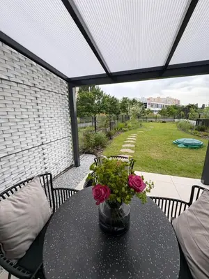a table with a vase of flowers on a patio at Beta Home - Free Garage, Air Condition, Garden, at Metro, 2nd parking on request in Prague