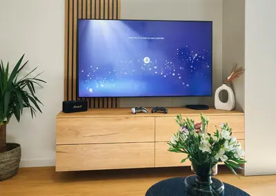 a tv sitting on top of a wooden dresser at Beta Home - Free Garage, Air Condition, Garden, at Metro, 2nd parking on request in Prague