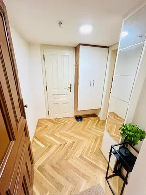 a room with a wooden floor and a door at Cozy Design Homestay with terrace in Prague