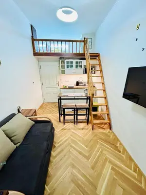 a living room with a couch and a table at Cozy Design Homestay with terrace in Prague