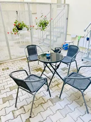 a patio with four chairs and a table and a table and chairs at Cozy Design Homestay with terrace in Prague