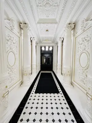 a hallway with a black and white checkered floor at Cozy Design Homestay with terrace in Prague