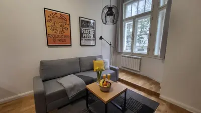 a living room with a couch and a table at Endless Jecna in Prague