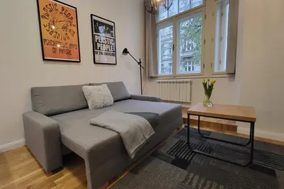 a living room with a couch and a table at Endless Jecna in Prague