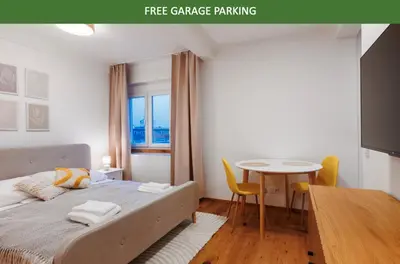 a bedroom with a bed and a table and a dining room at 1 bedroom apartment with terrace and FREE parking near metro in Prague