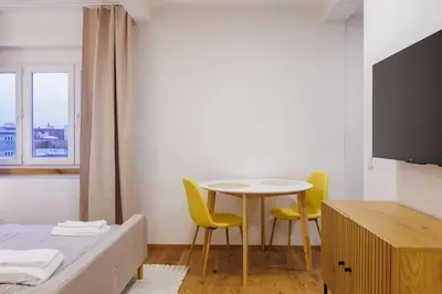 a room with a bed and a table and two chairs at 1 bedroom apartment with terrace and FREE parking near metro in Prague