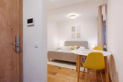 a bedroom with a bed and a table and chairs at 1 bedroom apartment with terrace and FREE parking near metro in Prague