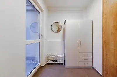 a bathroom with white walls and a large window at 1 bedroom apartment with terrace and FREE parking near metro in Prague