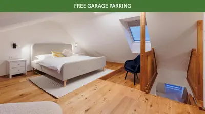 a bedroom with a white bed and a blue chair at 2 rooms apartment with terrace and FREE parking near metro in Prague
