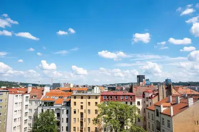 a view of a city with buildings and a blue sky at 2 rooms apartment with terrace and FREE parking near metro in Prague