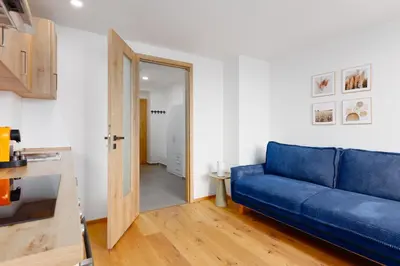 a living room with a blue couch and a door at 2 rooms apartment with terrace and FREE parking near metro in Prague