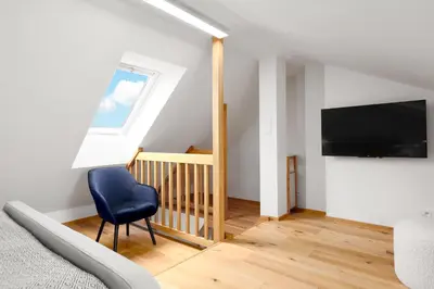 a living room with a tv and a blue chair at 2 rooms apartment with terrace and FREE parking near metro in Prague