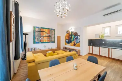 a living room with a yellow couch and a table at Apartmán Praha Žižkov - DZ RENT in Prague