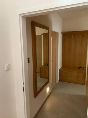a hallway with a mirror in a bathroom at Apartmán Praha Žižkov - DZ RENT in Prague