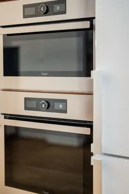 a kitchen with an oven with a microwave at Apartmán Praha Žižkov - DZ RENT in Prague