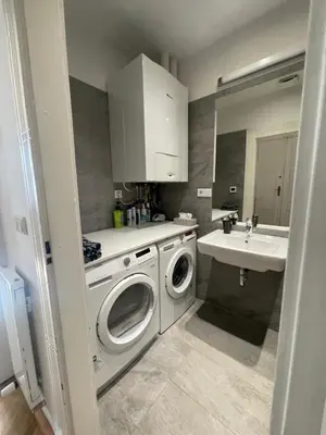 a kitchen with a washing machine and a sink at River View Apartment MANES in Prague