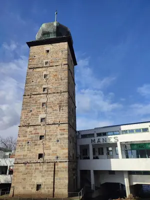 a tall brick tower sitting next to a building at River View Apartment MANES in Prague