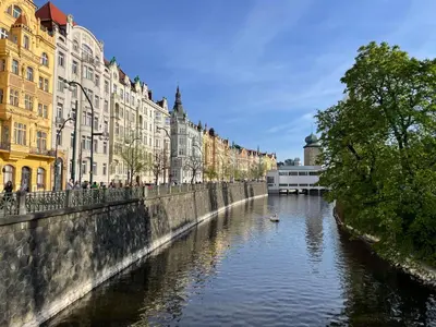 a river in the middle of a city with buildings at River View Apartment MANES in Prague