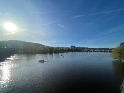 an aerial view of a river with boats on it at River View Apartment MANES in Prague