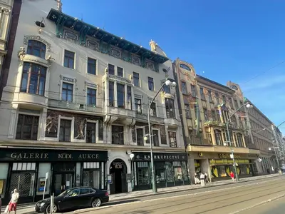 a building on a street with a car parked in front at River View Apartment MANES in Prague
