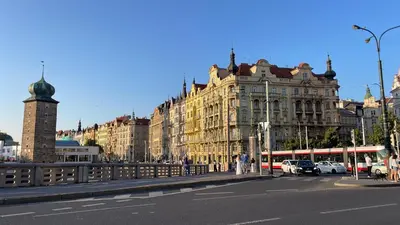 a city with buildings and a street with a bus at River View Apartment MANES in Prague