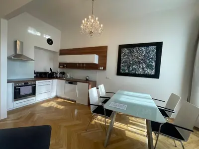 a kitchen and dining room with a table and chairs at River View Apartment MANES in Prague