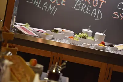 a buffet with several dishes of food on a table at Hotel Esprit in Prague
