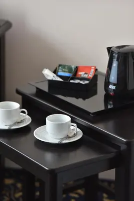 two coffee cups and saucers on a table at Hotel Esprit in Prague