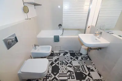 a bathroom with two sinks and a toilet and a tub at Prague apartment Spalena in Prague