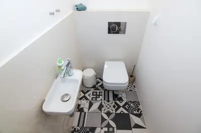 a white bathroom with a sink and a toilet at Prague apartment Spalena in Prague