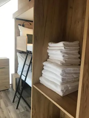 a stack of towels on a shelf in a room at Marina&Glamping Nova Zivohost in Neveklov