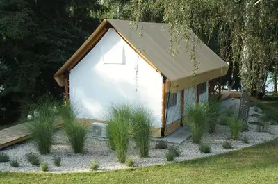 a small white building with a roof at Marina&Glamping Nova Zivohost in Neveklov