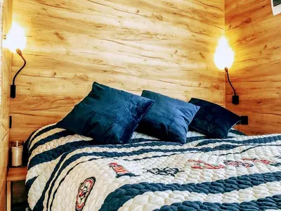a bedroom with a bed with two lights on it at Marina&Glamping Nova Zivohost in Neveklov