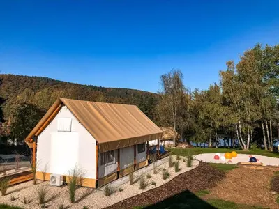 a small white shed with a metal roof at Marina&Glamping Nova Zivohost in Neveklov