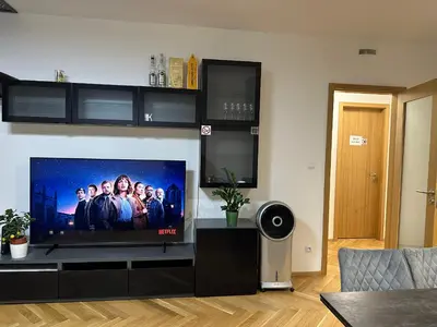 a living room with a large flat screen tv at Smichov city Apartments in Prague