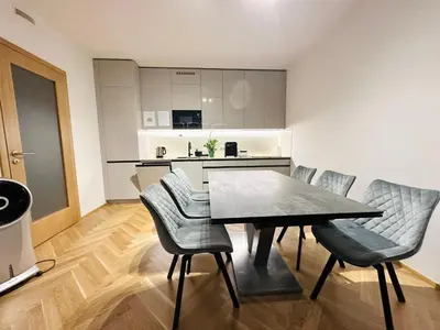 a kitchen and dining room with a table and chairs at Smichov city Apartments in Prague
