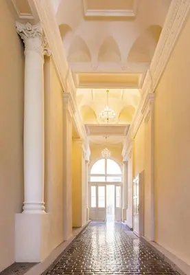 an empty hallway with columns and a large window at Cozy Design Homestay right next to Wenceslas Square in Prague