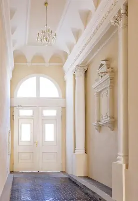 a hallway with a white door and a chandelier at Cozy Design Homestay right next to Wenceslas Square in Prague