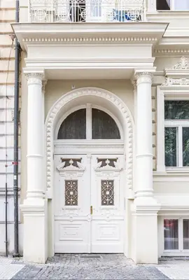 a white building with a large door at Cozy Design Homestay right next to Wenceslas Square in Prague
