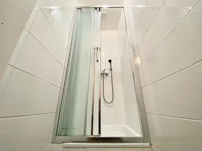 a shower with a glass door in a bathroom at Pop Art Rooms in Prague