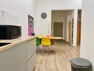 a kitchen with a table and chairs in a room at Pop Art Rooms in Prague