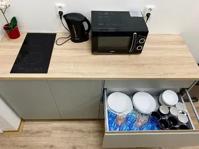 a microwave oven sitting on top of a wooden counter at Pop Art Rooms in Prague