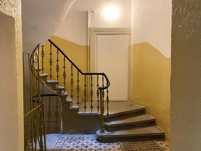 a staircase in an old house with a stair case at Pop Art Rooms in Prague