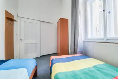 a bedroom with two beds and a window at Pop Art Rooms in Prague