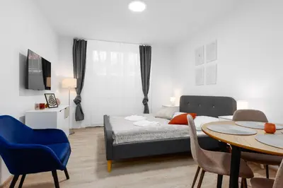 a bedroom with a bed and a table and chairs at 2 bedrooms apartment near the metro in Prague