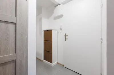 a room with a cross on the wall and a closet at 2 bedrooms apartment near the metro in Prague