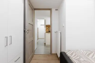 a bedroom with a door leading to a kitchen at 2 bedrooms apartment near the metro in Prague